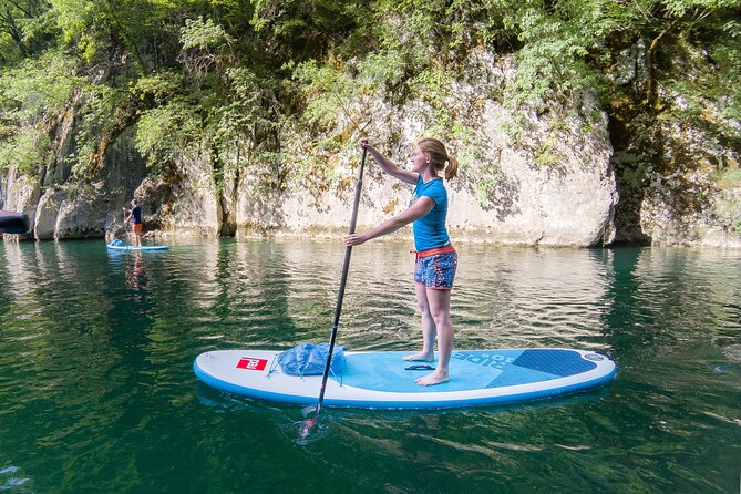 Private Half Day Stand-up Paddle Boarding on the Soča River - Learning to stand on the board at Lake Most na Soči